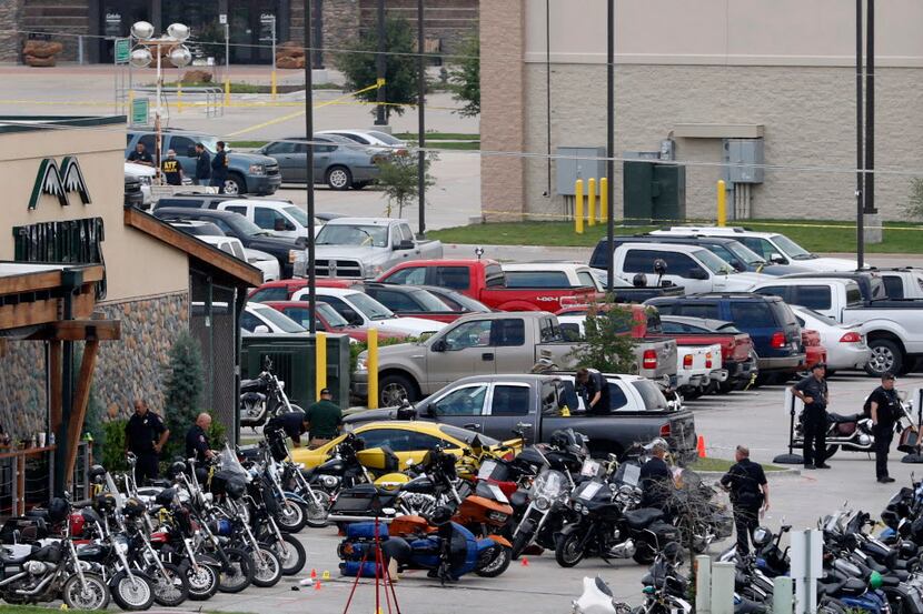 Authorities investigate a mass shooting at the Twin Peaks restaurant in Waco, Texas on May...