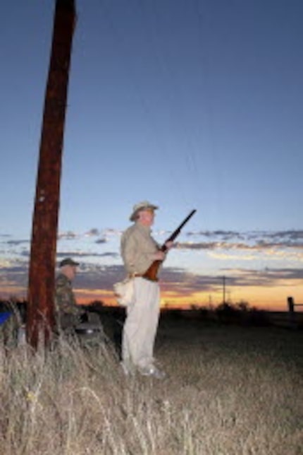   Boone Pickens, standing, and friend Harley Hotchkiss, on the opening day of 2010 dove...