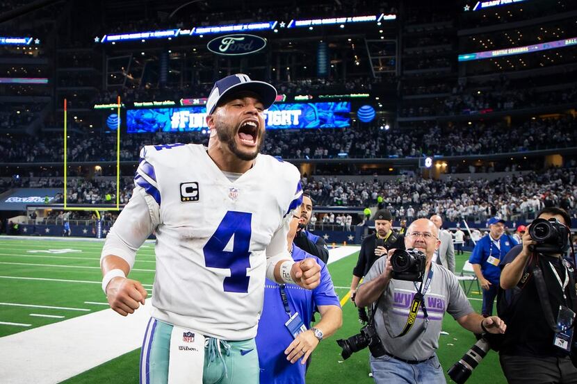 Dallas Cowboys quarterback Dak Prescott celebrates as he leaves the field following a...
