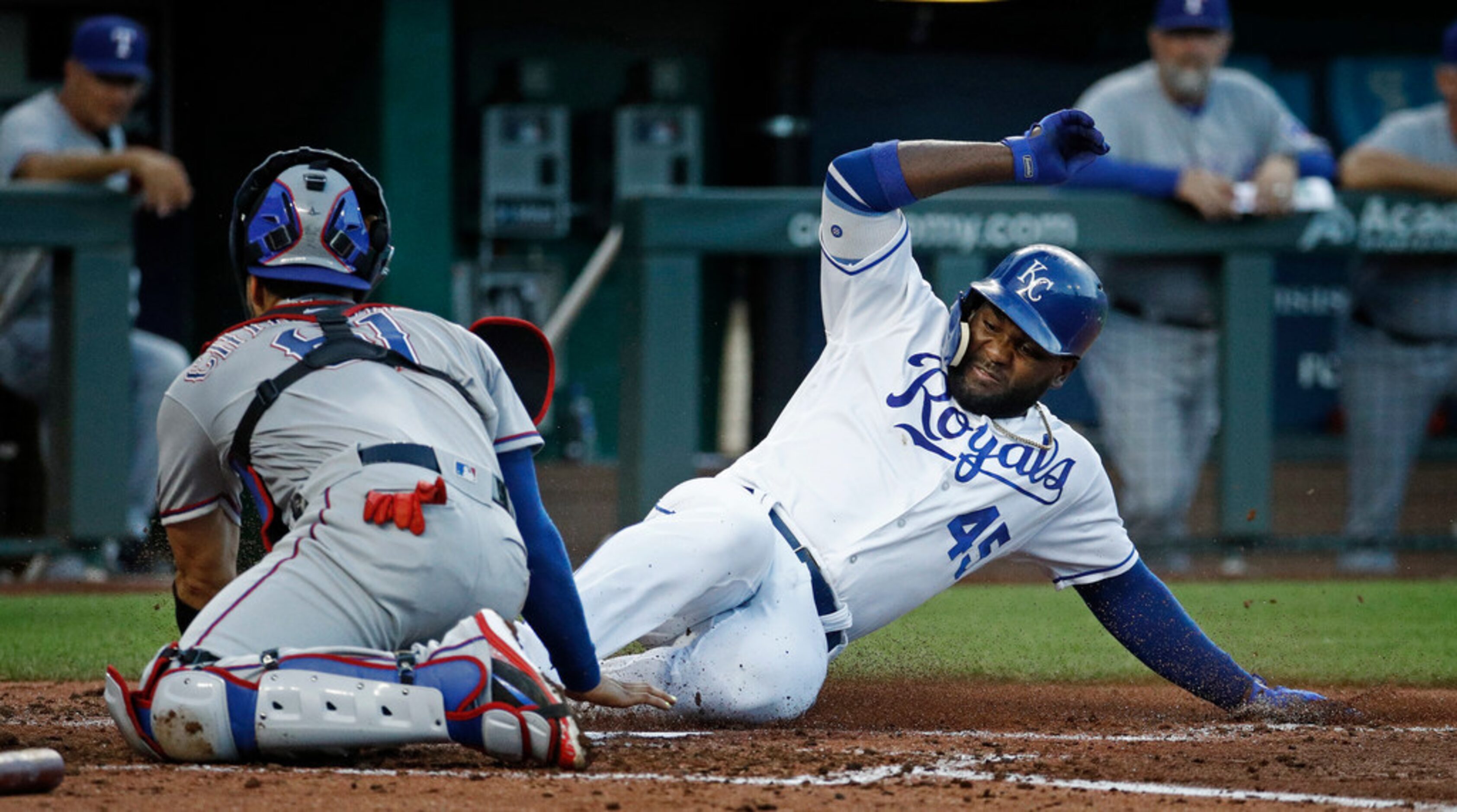 Kansas City Royals' Abraham Almonte (45) beats the tag by Texas Rangers catcher Robinson...