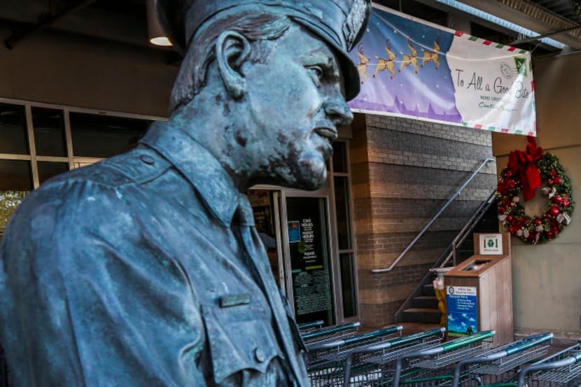 A statue of a police officer writing a citation is stationed outside the the Central Market...