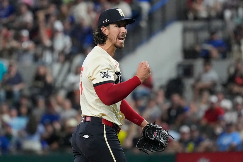 Texas Rangers starting pitcher Michael Lorenzen reacts after a third strike and third out...