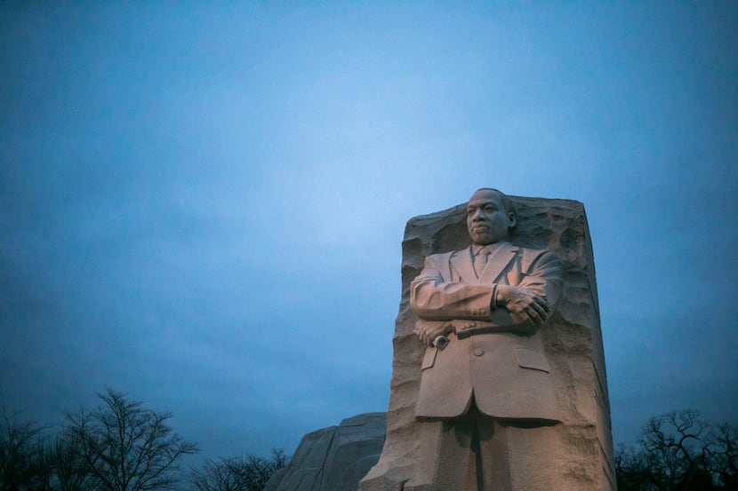 The Martin Luther King Jr. Memorial as the sun rises on a cloudy morning in Washington.