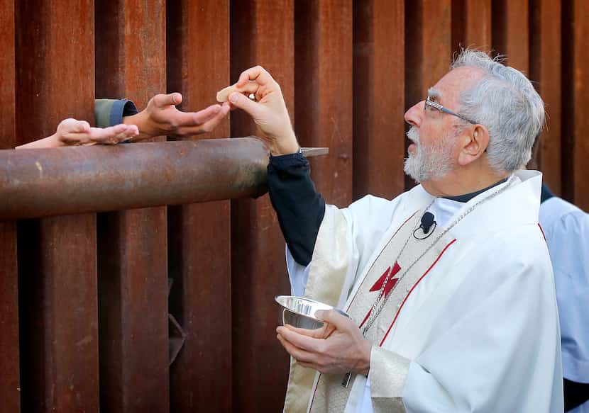  Most Reverend Gerald F. Kicanas, Bishop of Tucson, offers communion to people on the...