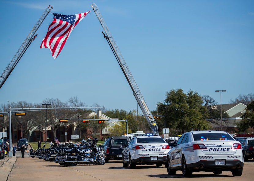  Police escort the body of Euless police officer David Hofer after a memorial service.