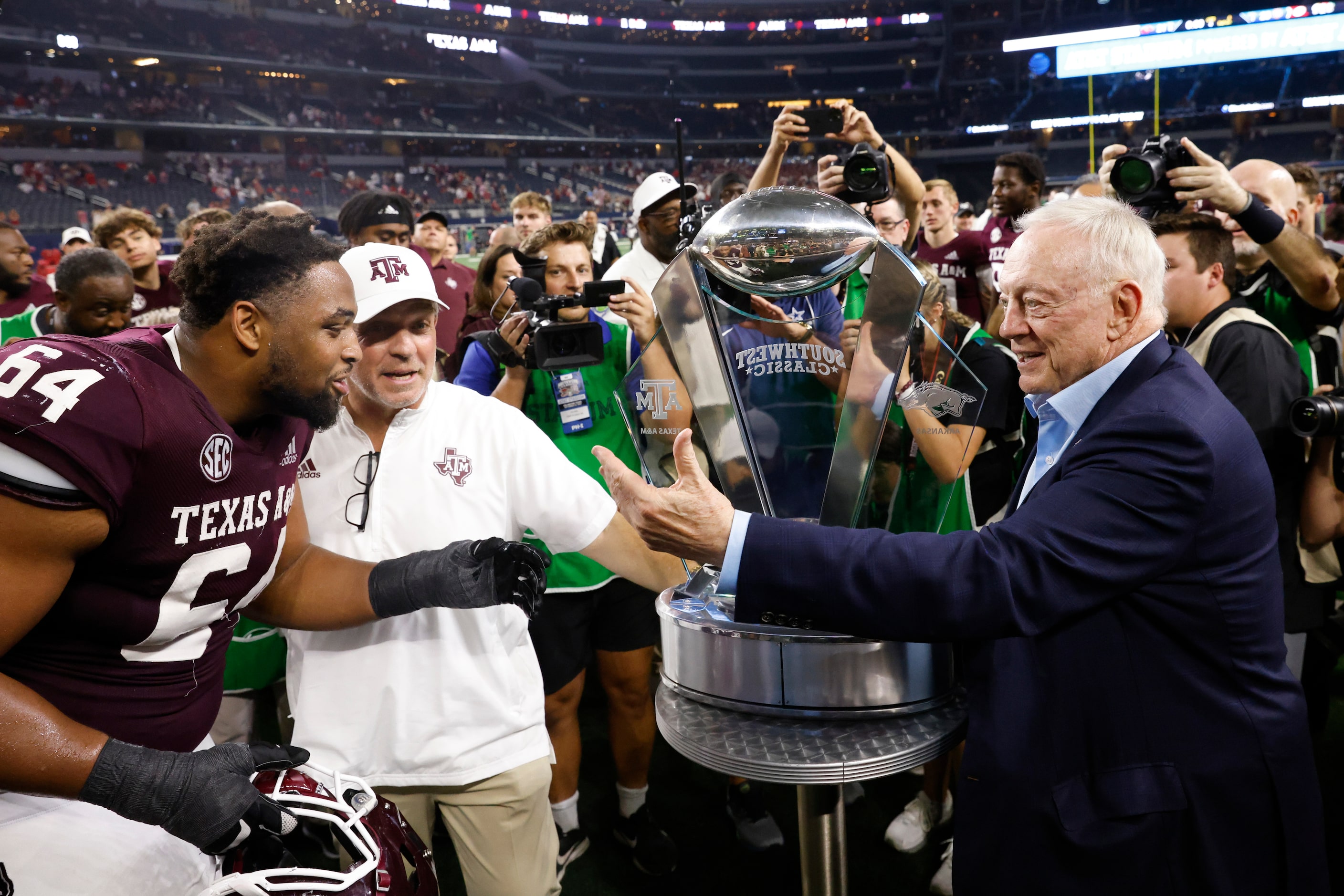 Dallas Cowboys owner Jerry Jones, right, calls Texas A&M offensive lineman Layden Robinson...