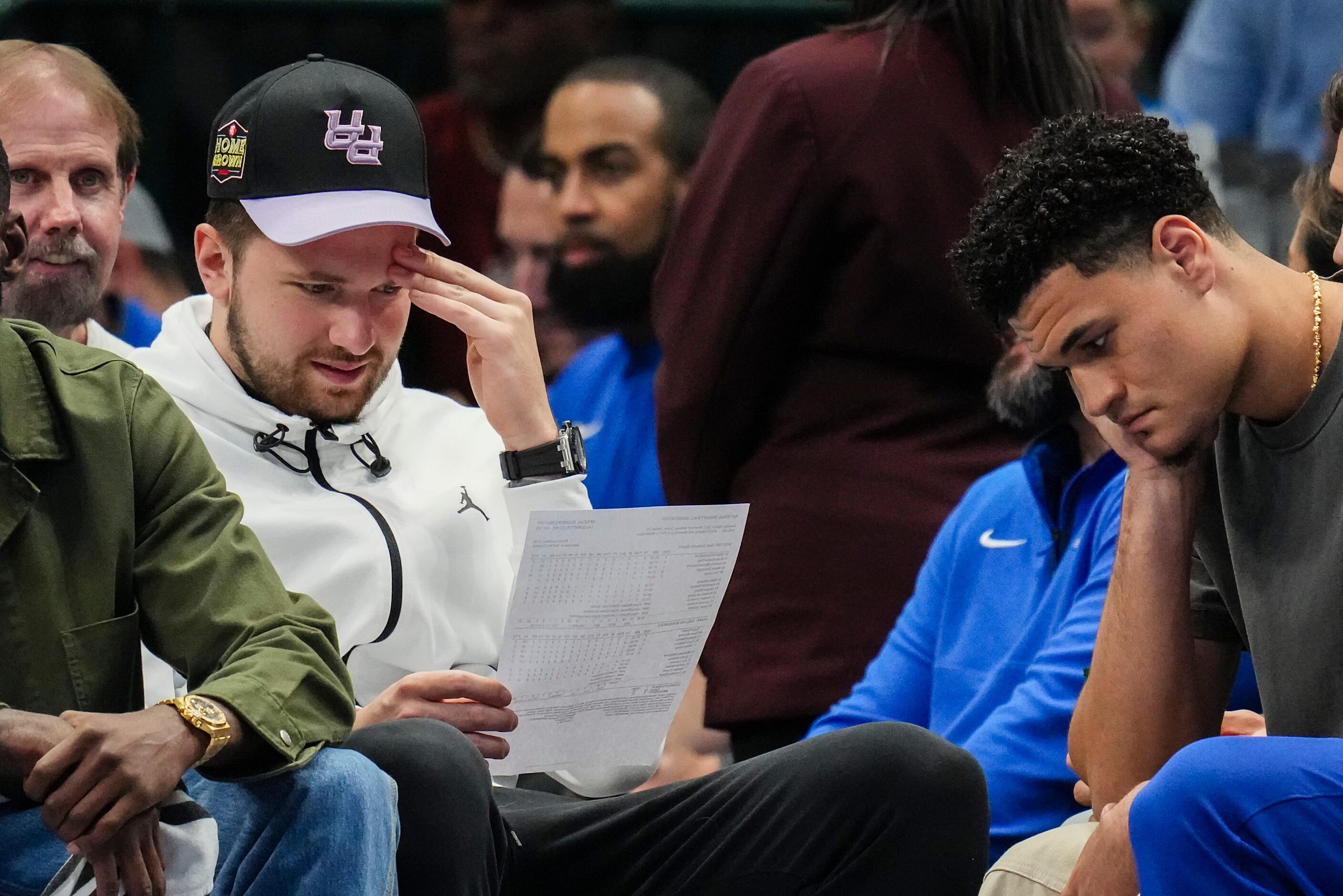 Dallas Mavericks guard Luka Doncic (left) watches from the bench with guard Josh Green...