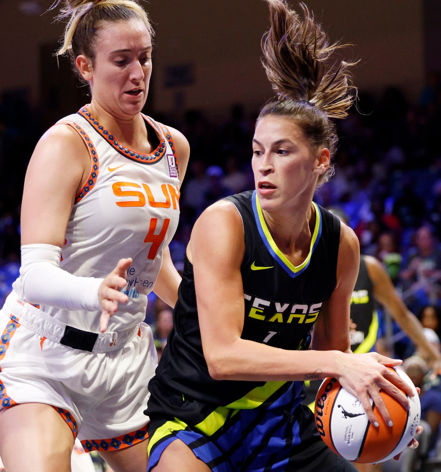 Dallas Wings guard Sevgi Uzun (1) tries to drive past Connecticut Sun guard Marina Mabrey...