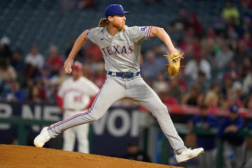 Texas Rangers starting pitcher Jon Gray throws to the mound during the first inning of a...