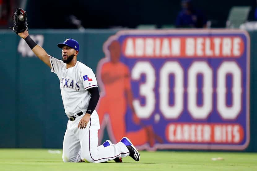 FILE - Rangers right fielder Nomar Mazara (30) comes up with a diving catch to end the top...