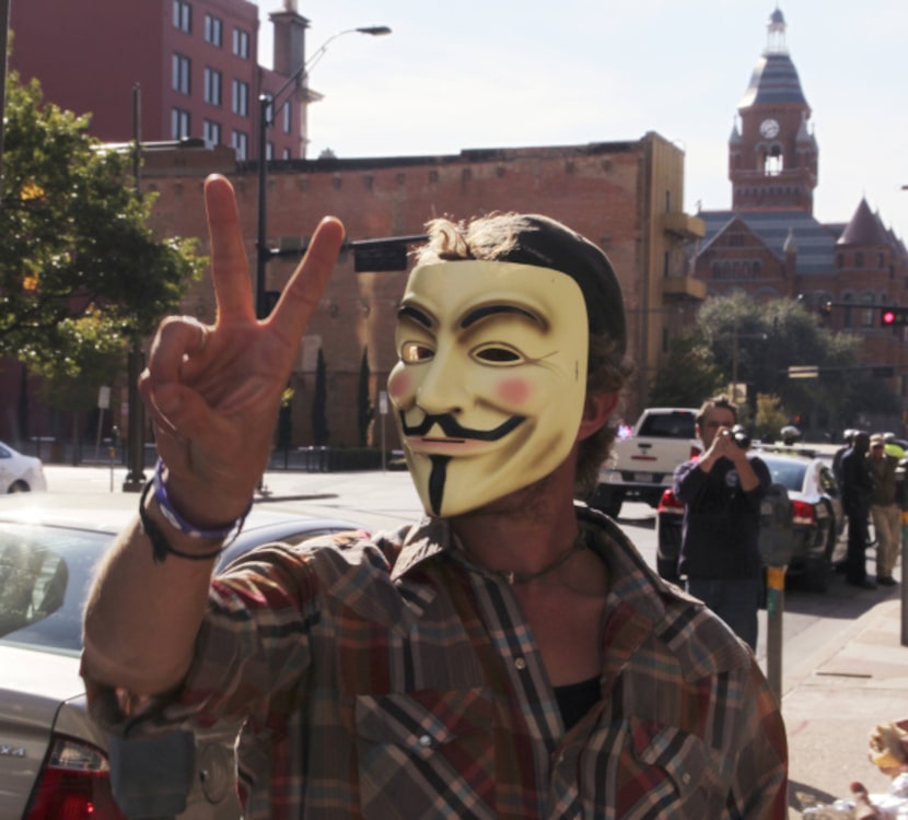 A protester donned a "V for Vendetta" Guy Fawkes mask during Saturday's protests....