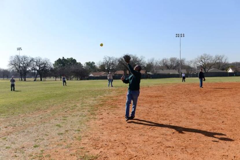 Faustino Coronado, 70, catches a ball during an Irving Eagles softball practice March 20 at...
