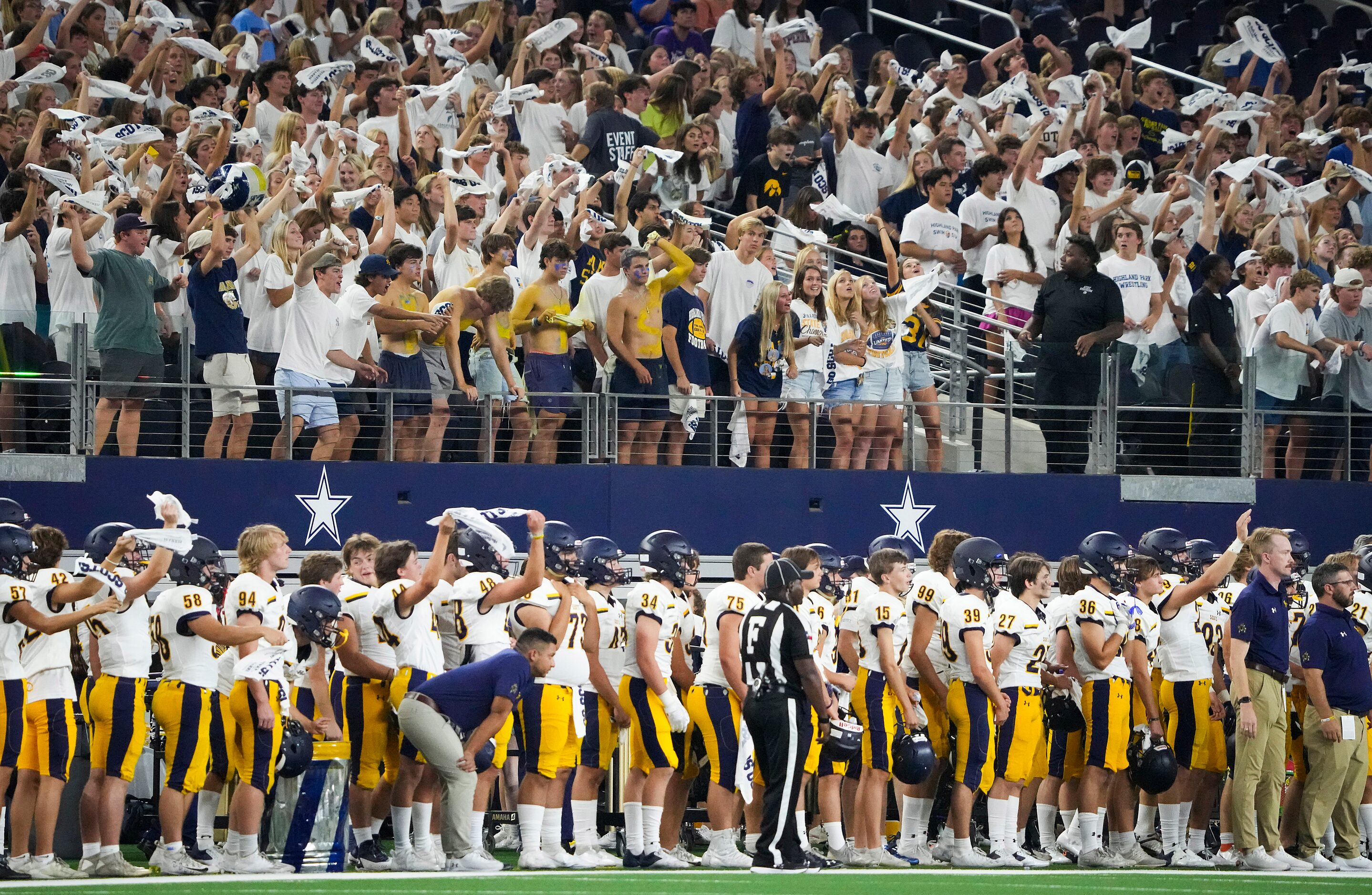 Highland Park fans cheer their defense during the first half of a high school football game...