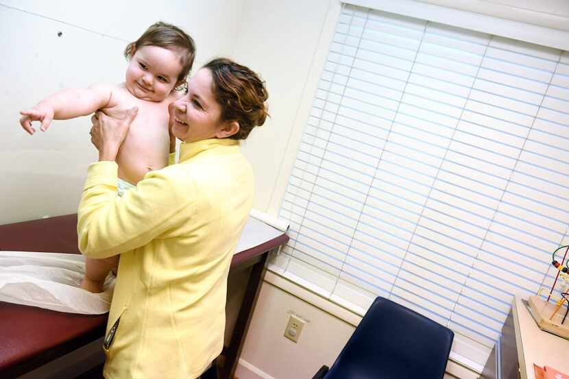 Marbell Castillo holds her granddaughter Maia Powell during the toddler's recent checkup at...