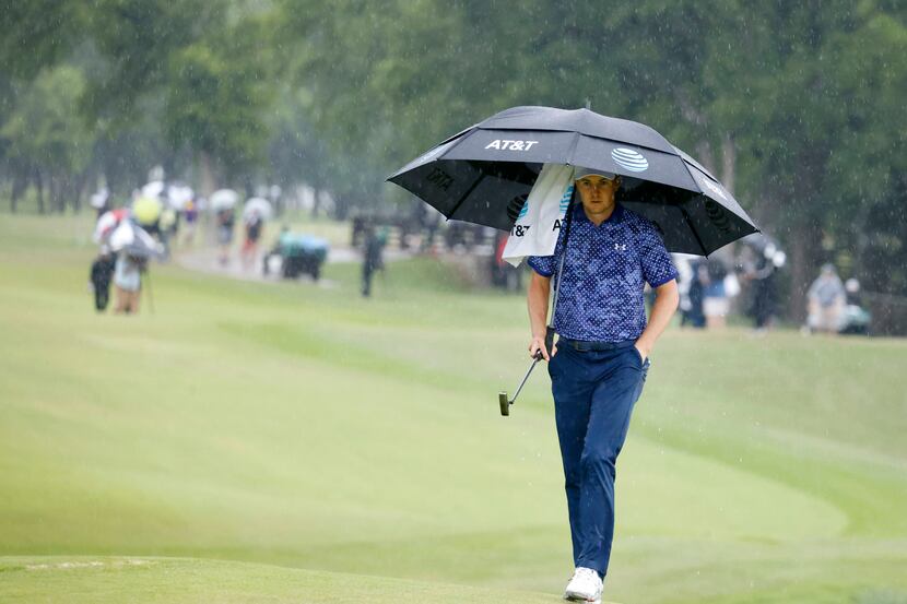 Jordan Spieth walks up to the green in the rain on the 9th hole during round 4 of the AT&T...