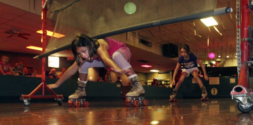 Seven year old Olivia Rose Johnson's shoulder touches the limbo bar at 22 inches to be...