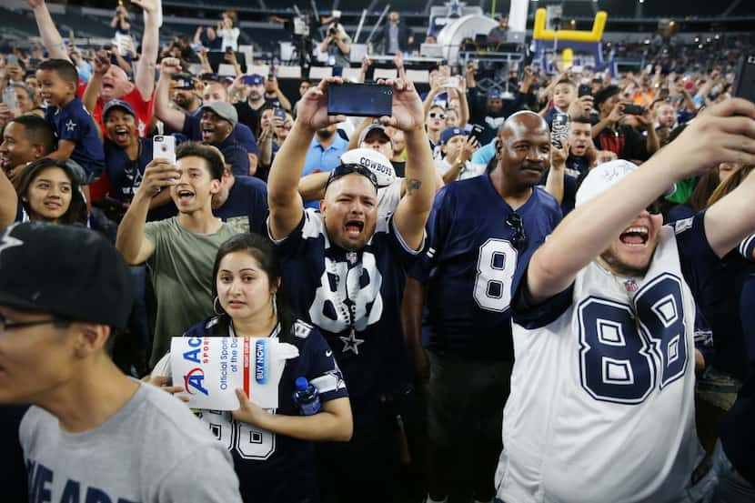 Mario Flores (center), of Dallas, reacts with other fans during a watch party as the Dallas...