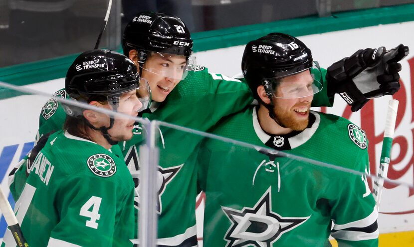 Dallas Stars left wing Jason Robertson (center) is congratulated on his late first period...