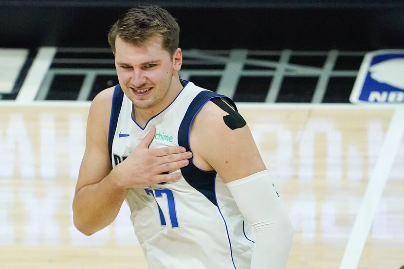 Dallas Mavericks guard Luka Doncic (77) celebrates after making a 3-pointer during the first...