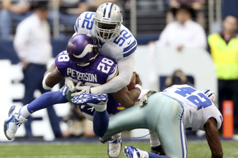 Dallas Cowboys outside linebacker Justin Durant (52) tackles Minnesota Vikings running back...