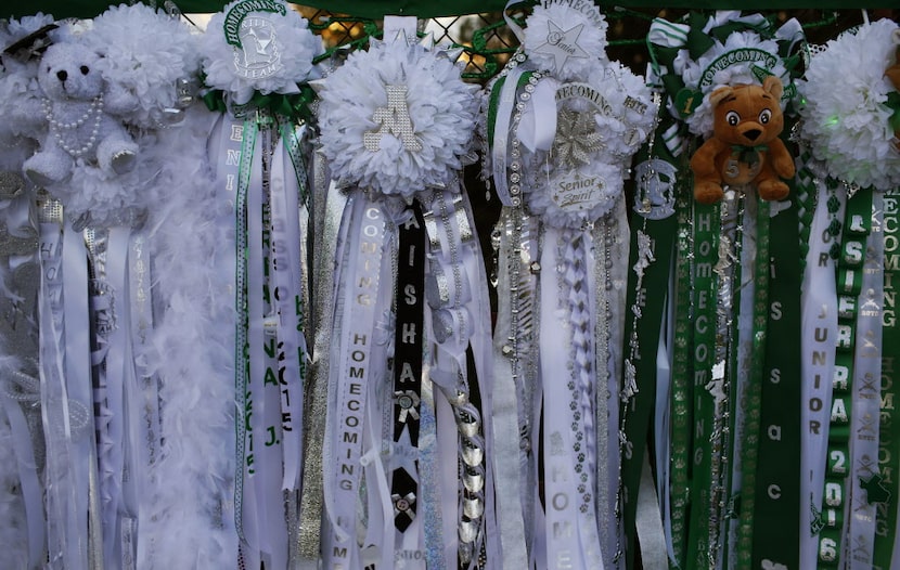 A selection of mums for the Bryan Adams homecoming game hang on the fence before their game...