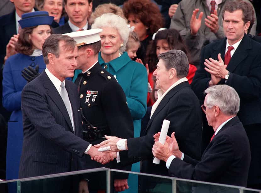 1989: Outgoing President Ronald Reagan congratulates newly inaugurated President George H.W....