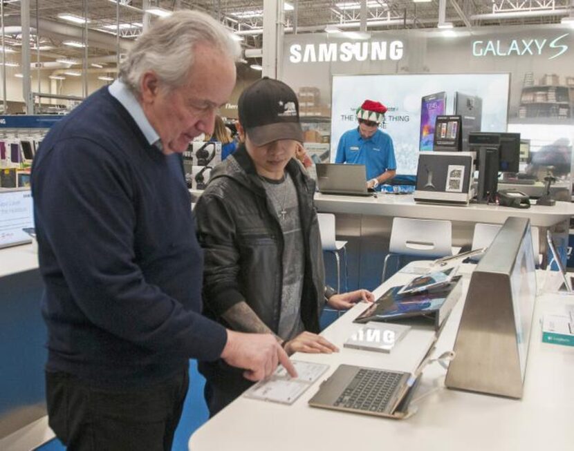 
Al Milano helps his son, Victor, pick out a tablet. Games drive the bulk of app revenue,...