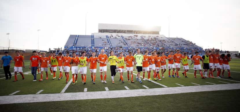 Frisco Wakeland players join arms after their loss to Trophy Club Byron Nelson during their...
