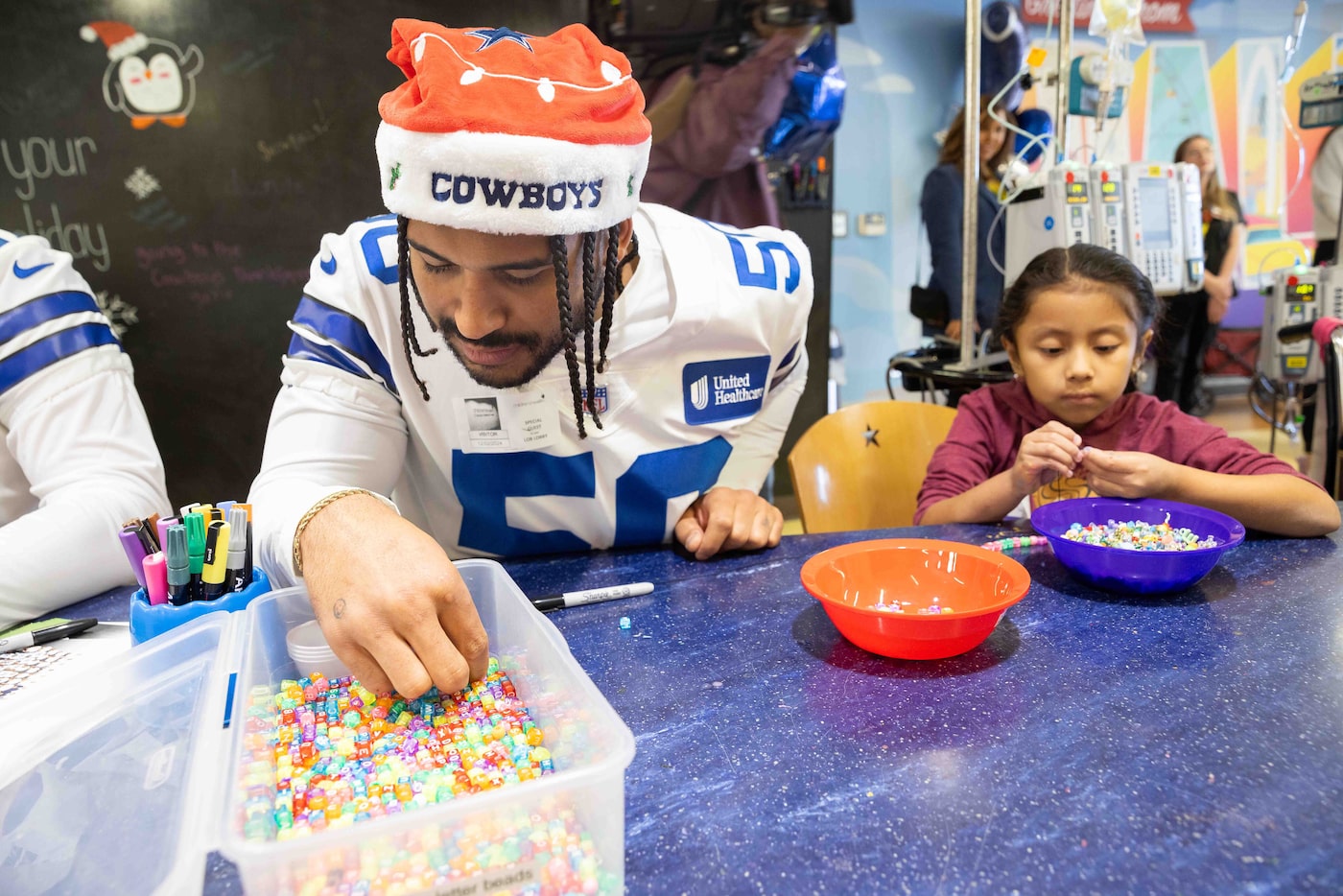 Dallas Cowboys linebacker Eric Kendricks (50) looks through the beads while making a...