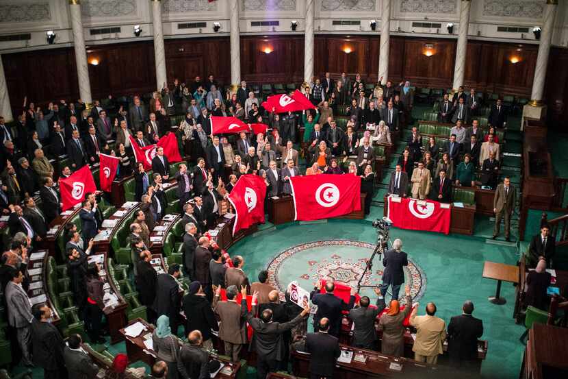 In this 2014 file photo, members of the Tunisian National Constituent Assembly celebrate the...