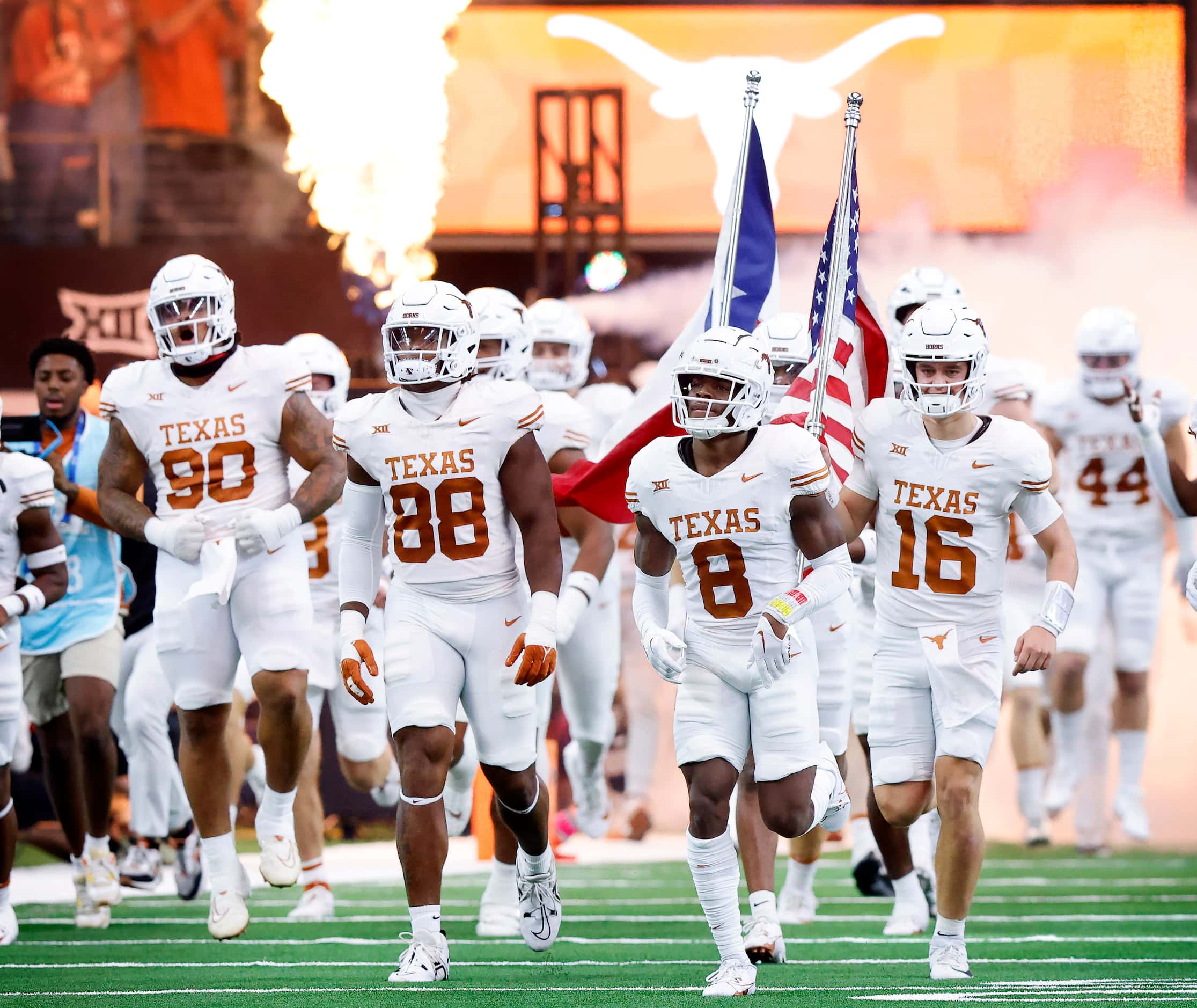 The Texas Longhorns football team races onto the field during team introductions before the...