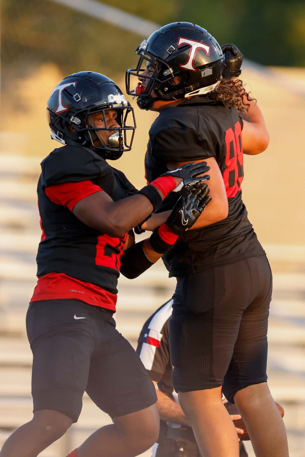 Euless Trinity running back Josh Bell (20) celebrates his touchdown with a teammate during...
