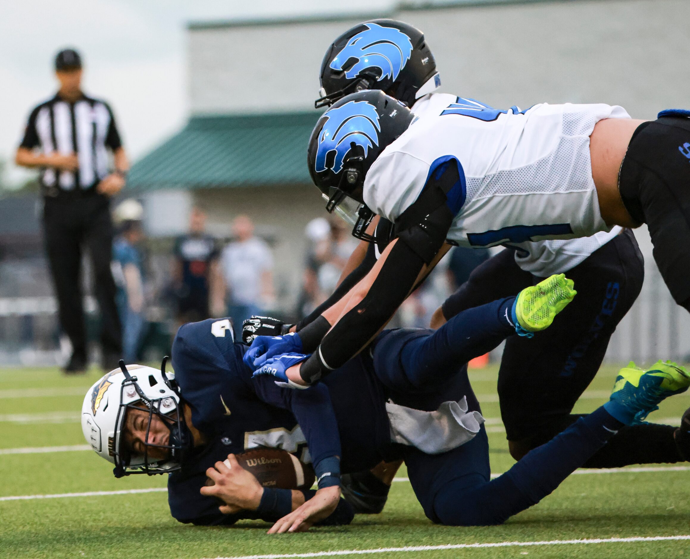 Keller High School Tre Guerra (3) gets tackled by Plano West Senior High Noah Hann (44) and...