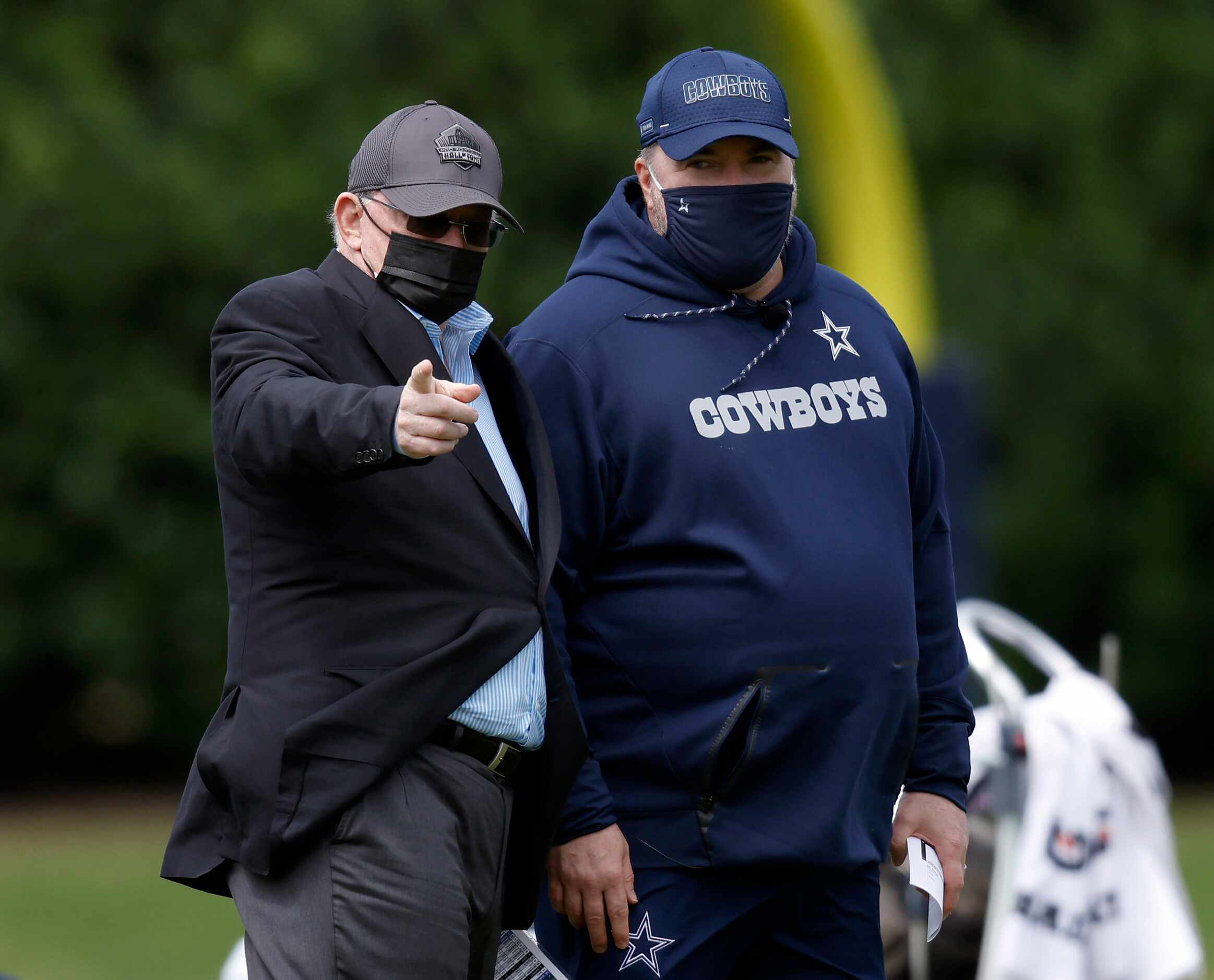 Dallas Cowboys owner Jerry Jones (left) and head coach Mike McCarthy visit on the sideline...