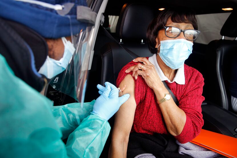 Marian Barnett of Lancaster receives her 2nd COVID-19 vaccination from volunteer pharmacist...