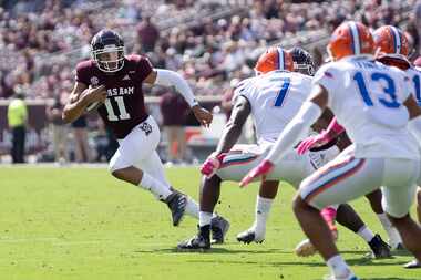 Texas A&M quarterback Kellen Mond (11) looks to run against Florida linebacker Jeremiah Moon...