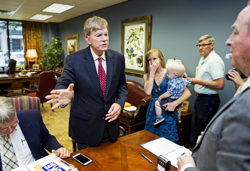 Former Ku Klux Klan leader David Duke talks with qualifying officer Joe R. Salter, right, at...