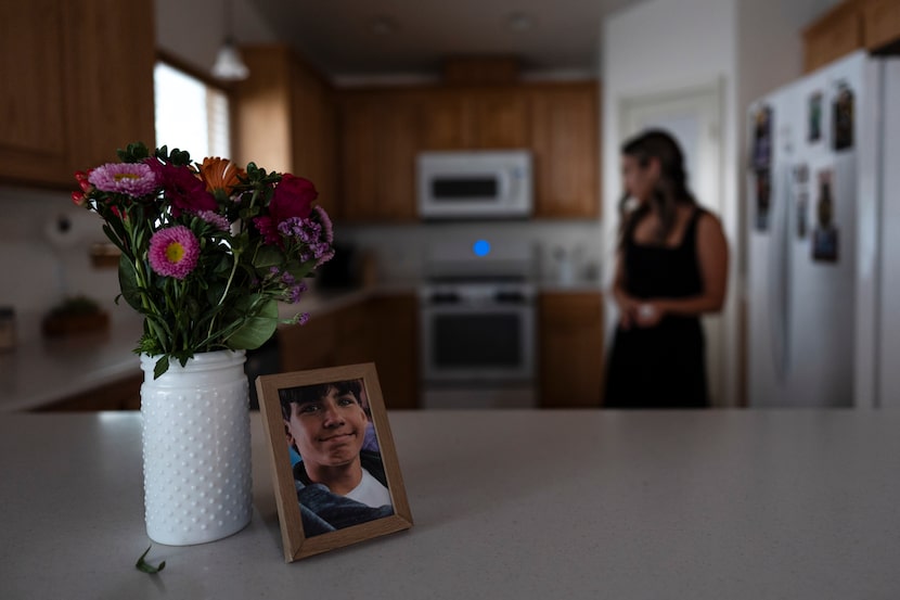 A framed photo of Elijah Ott, who died of a fentanyl overdose at 15, is shown as his mother,...