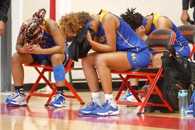 Members of the Lakeview Centennial girls basketball team react after falling 49-42 to...