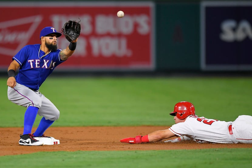 Los Angeles Angels' Mike Trout, right, steals second as Texas Rangers second baseman Rougned...
