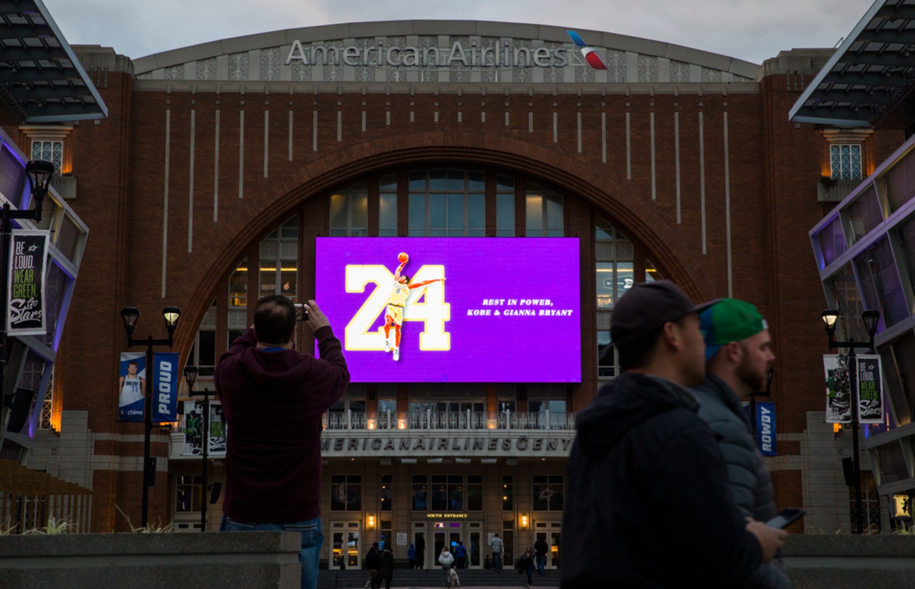 Large screens display a tribute to former Los Angeles Laker Kobe Bryant and his daughter,...