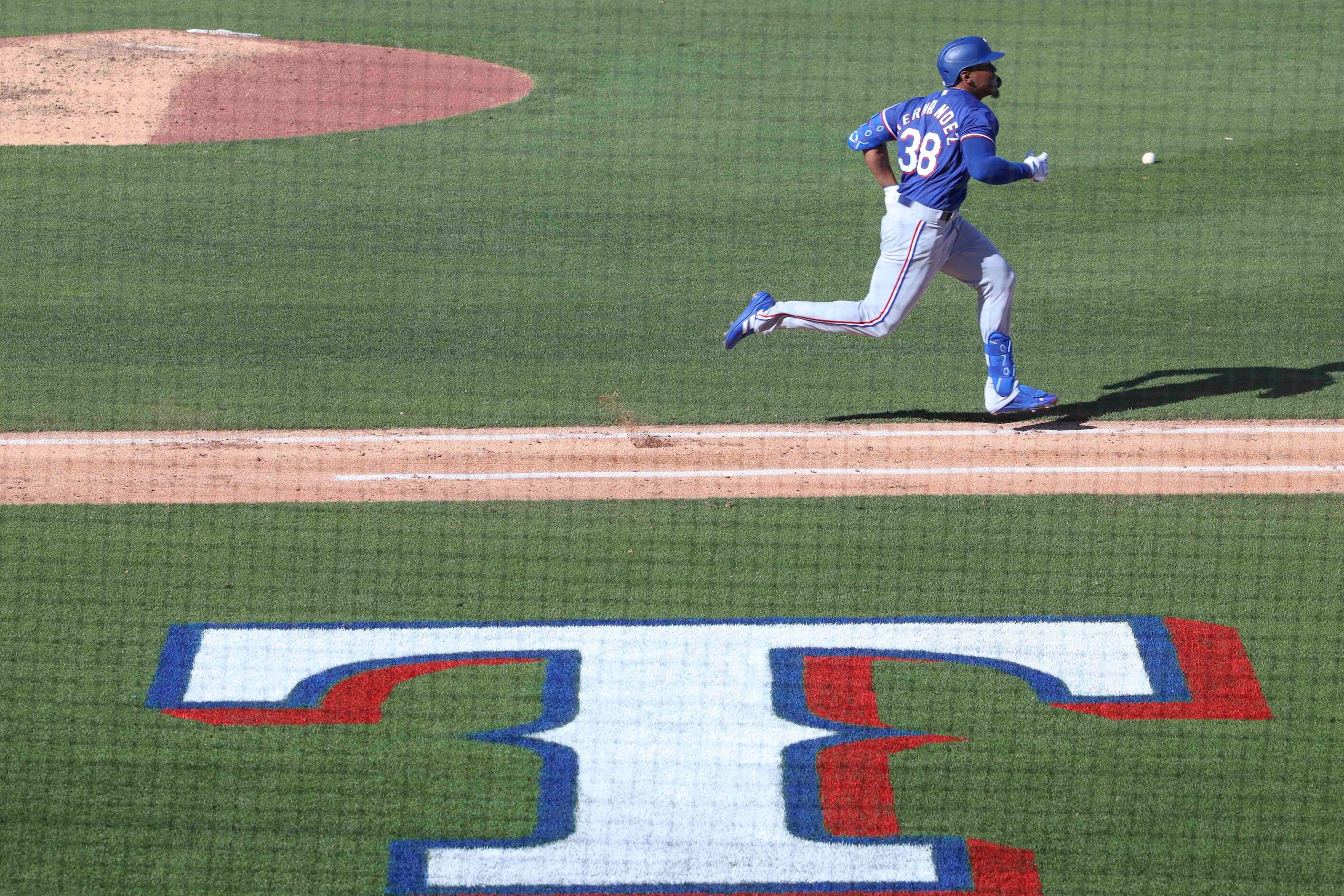 Texas Rangers Elier Hernandez run safely to first base during the eight inning of a spring...