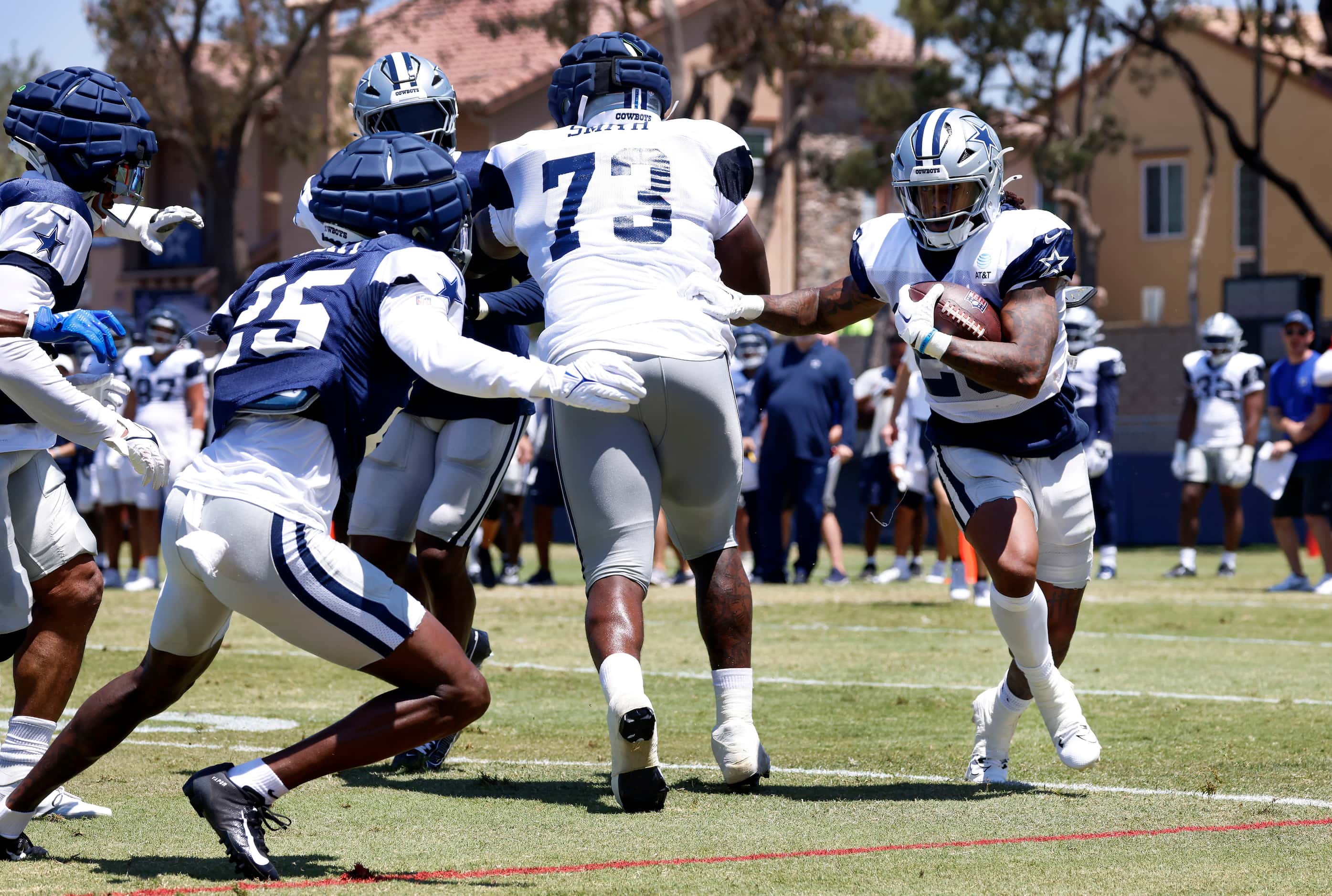 Dallas Cowboys running back Rico Dowdle (23) pushes off of offensive tackle Tyler Smith (73)...