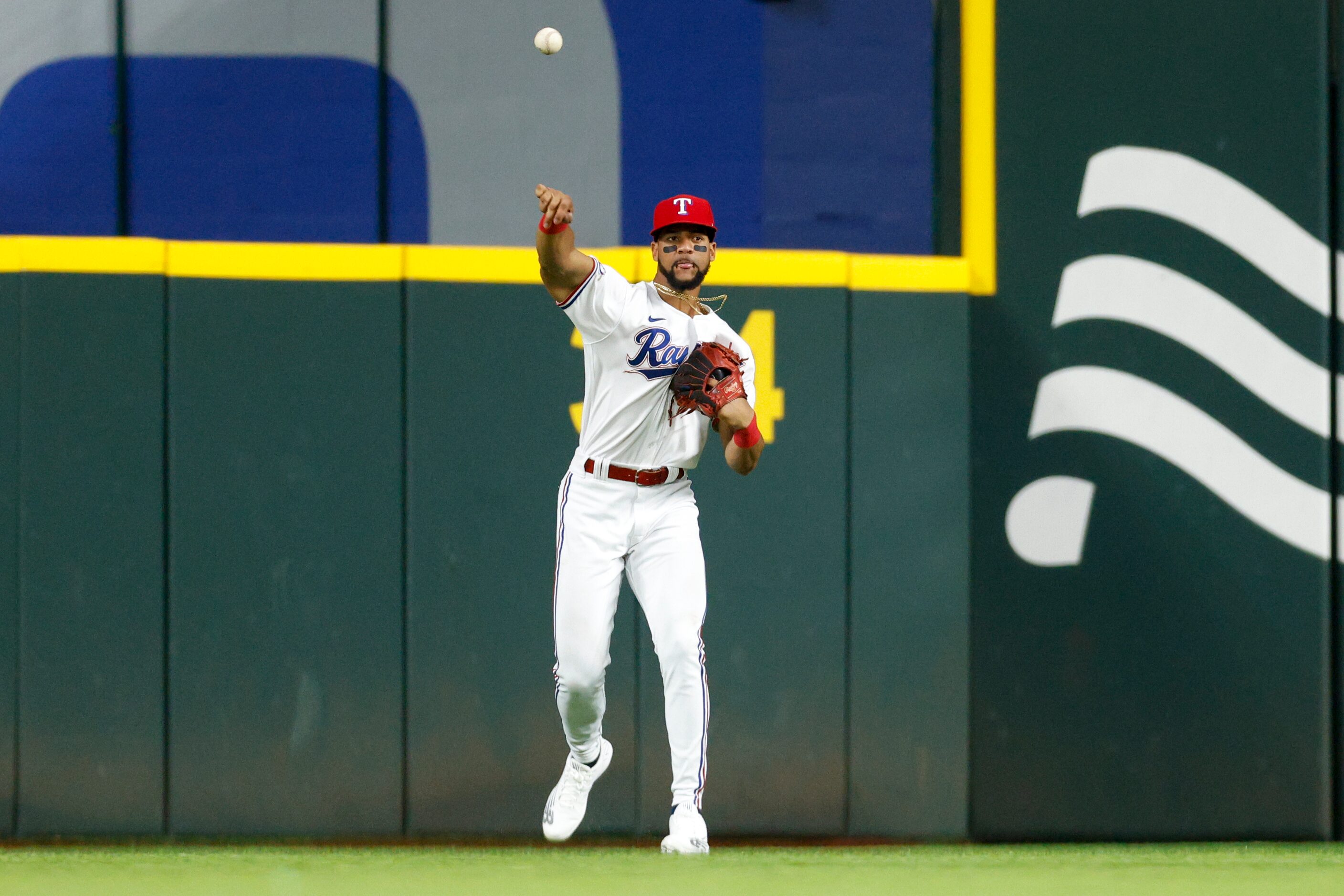 Texas Rangers center fielder Leody Taveras (3) throws the ball to the infield after a single...