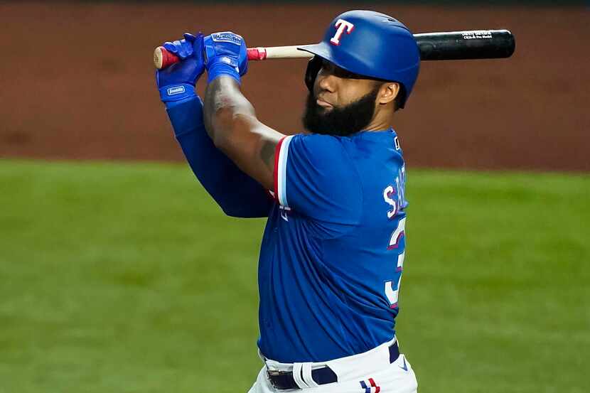 Texas Rangers outfielder Danny Santana bats during the first inning of an exhibition game at...