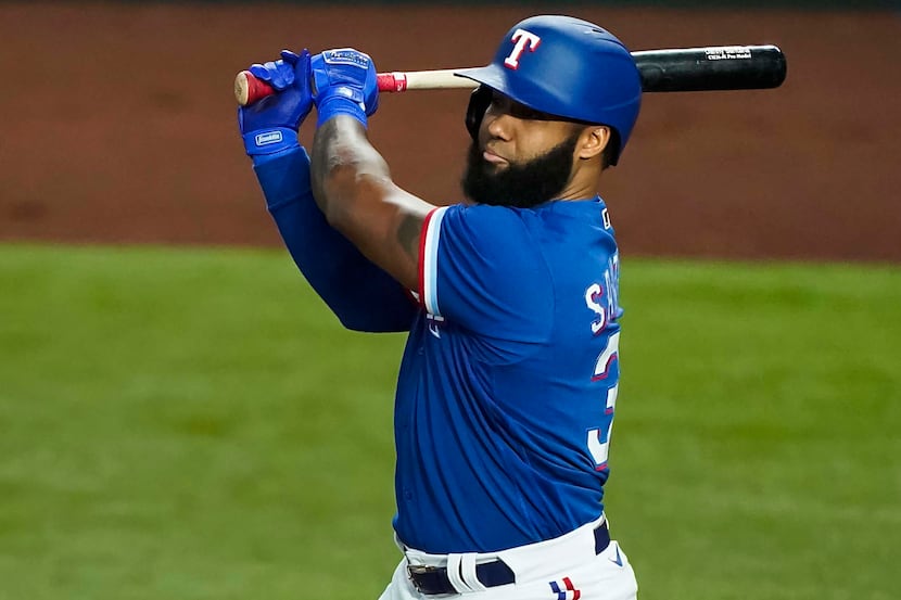 Texas Rangers outfielder Danny Santana bats during the first inning of an exhibition game at...