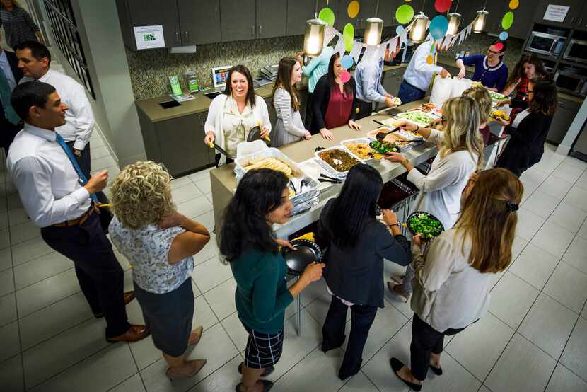 Northwestern Mutual employees fill their plates with a catered fajita lunch at their offices...