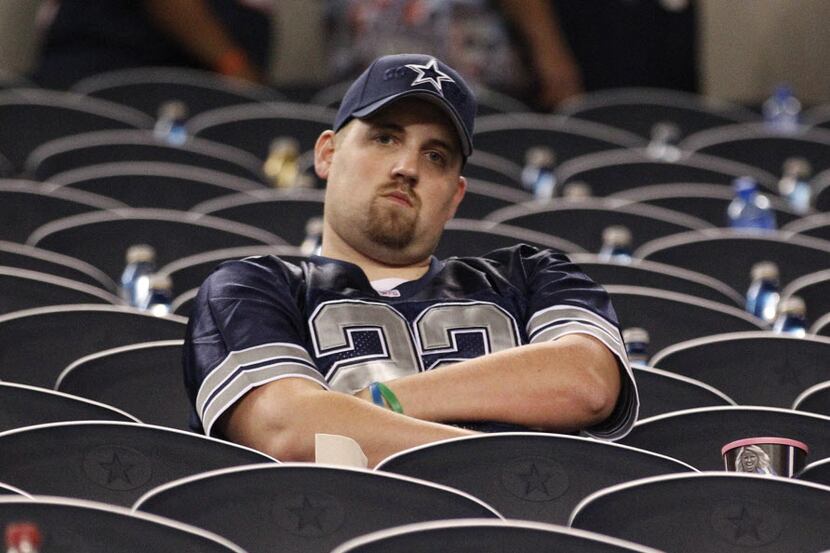 A lone Dallas Cowboys fan sits in the stands after the loss to the Chicago Bears in the NFL...