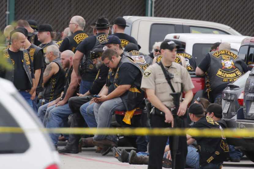  In this May 17, 2015 file photo, a McLennan County deputy stands guard near a group of...