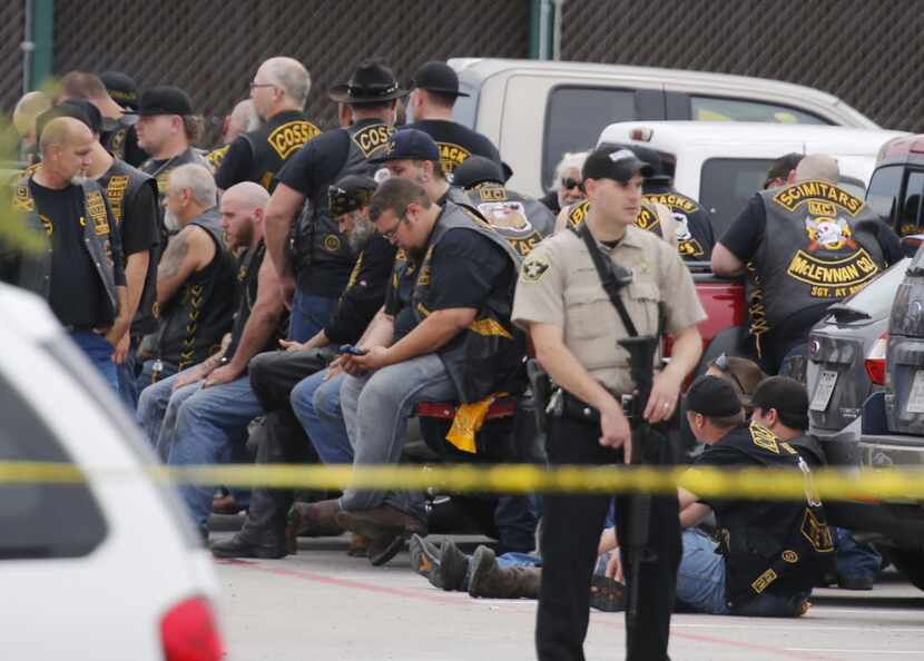  In this May 17, 2015 file photo, a McLennan County deputy stands guard near a group of...